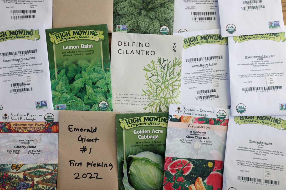 An array of seed packets are laid out on a table.