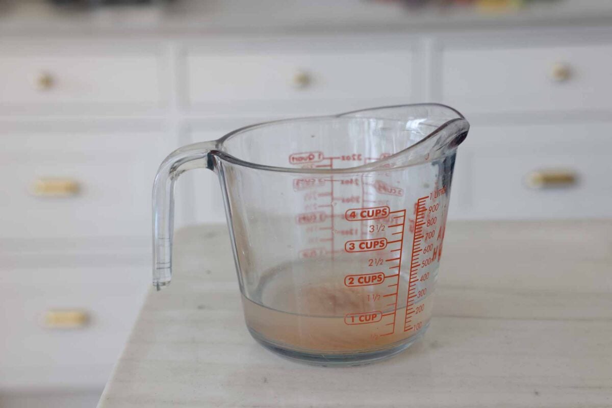 A liquid measuring cup filled with a salt brine.