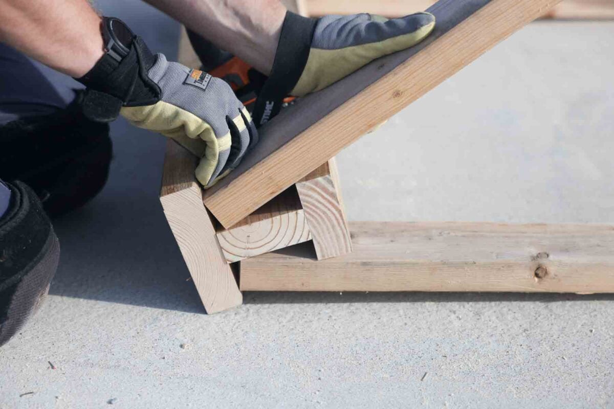 Screwing the third leg on to the sawhorse
