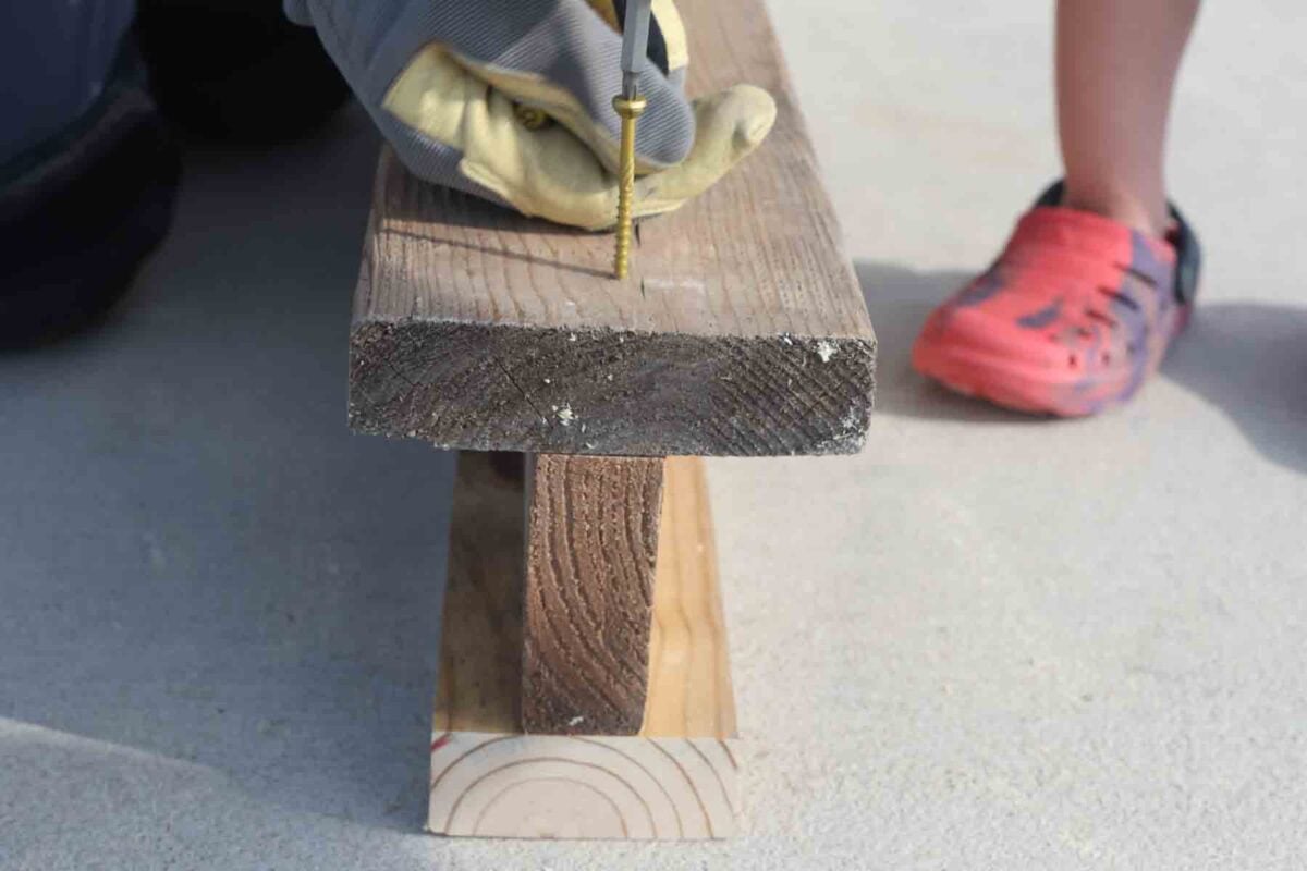 closeup of screwing the i-beam pieces into place