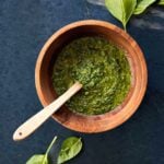 Basil pesto made with walnuts in a wooden bowl.