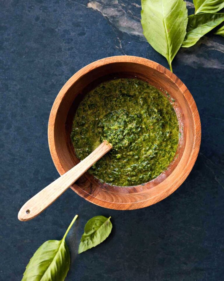 Basil pesto made with walnuts in a wooden bowl.