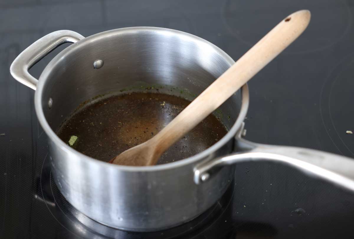 jerky marinade ingredients in a saucepan, heating up on a stovetop