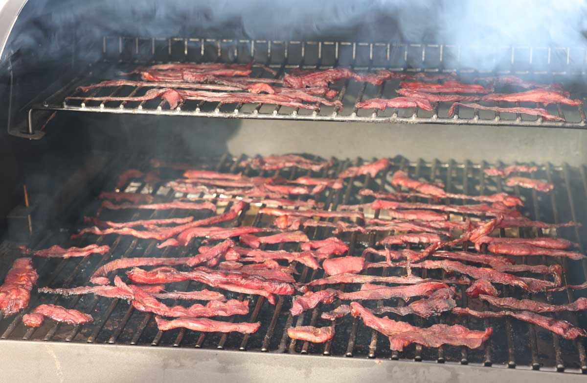 smoked beef jerky on the smoker, looking good