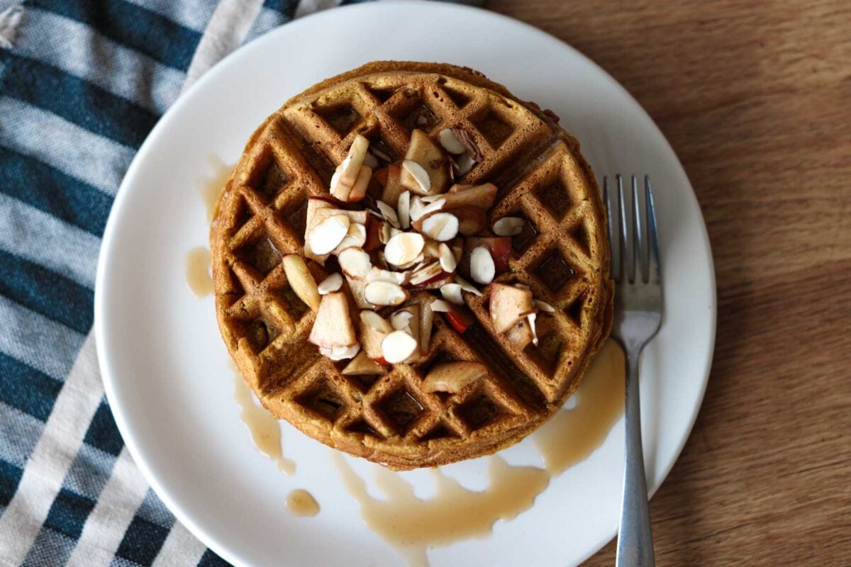 Waffle from above, drizzled with syrup and toppings