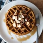 Waffle from above, drizzled with syrup and toppings