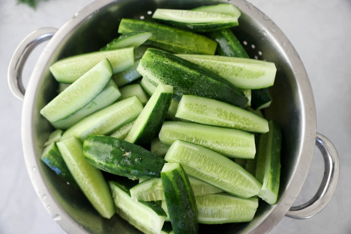 Chopped up cucumbers in spears in a bowl.