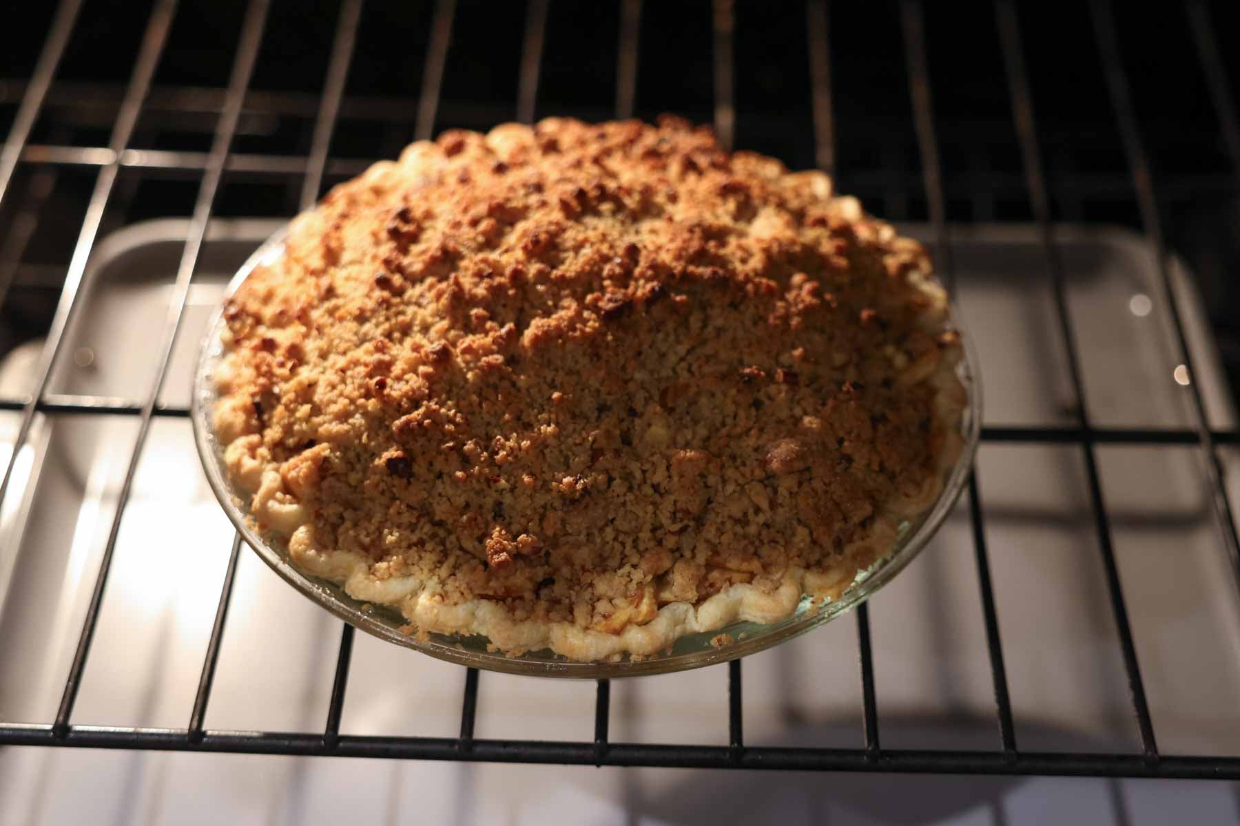 Dutch apple pie being baked on an oven rack.