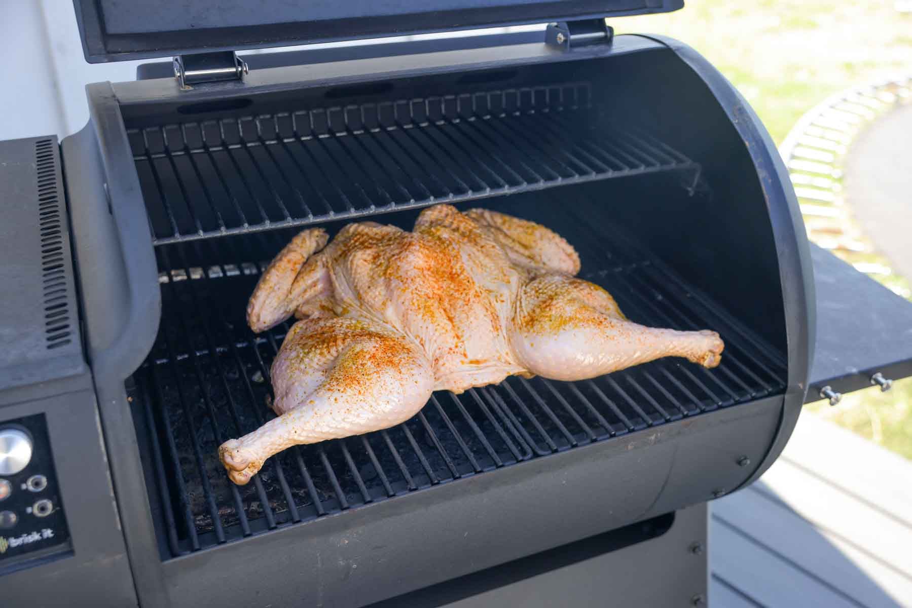 spatchcocked turkey on the smoker ready to cook