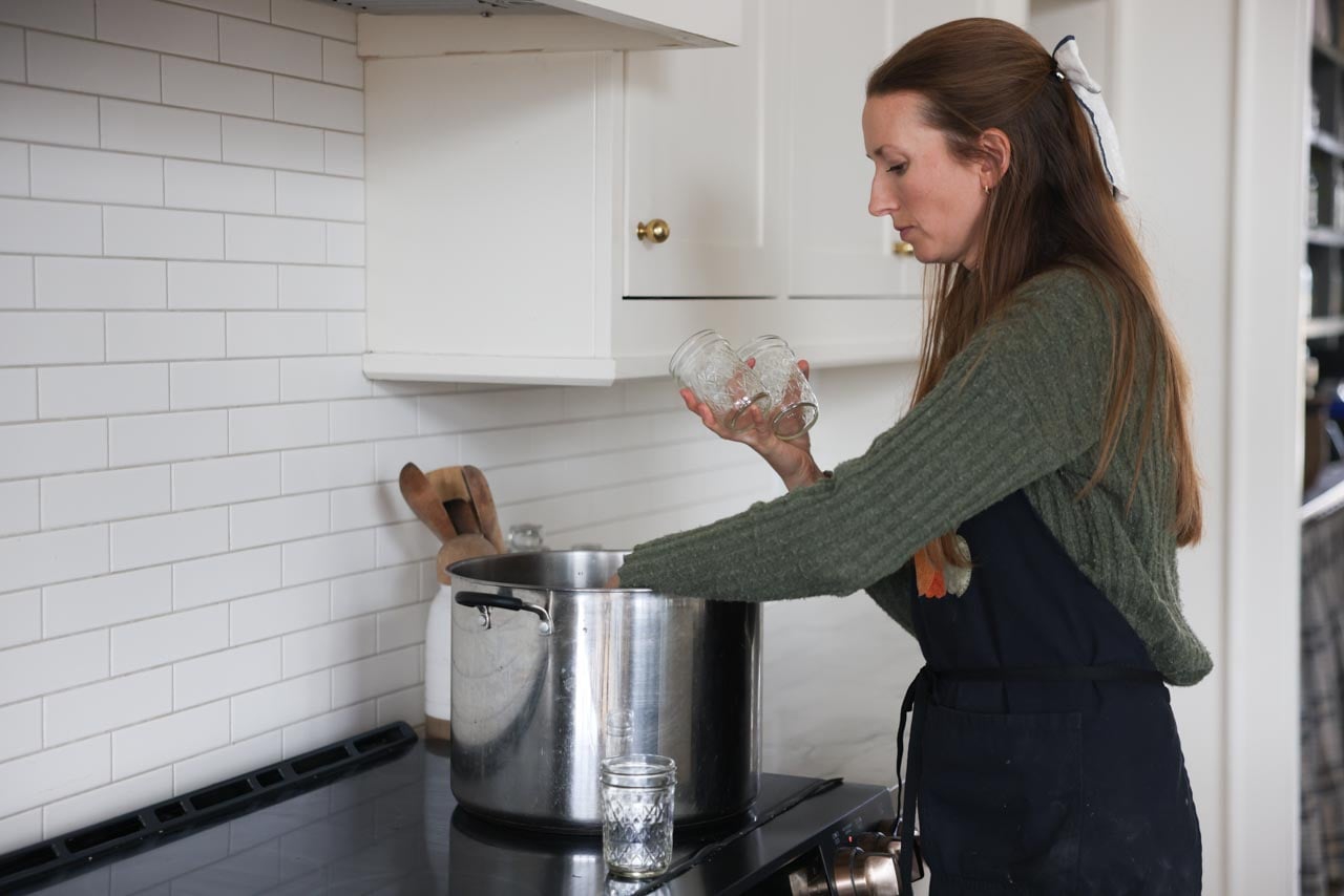 Canning jars are placed in a water bath canner.