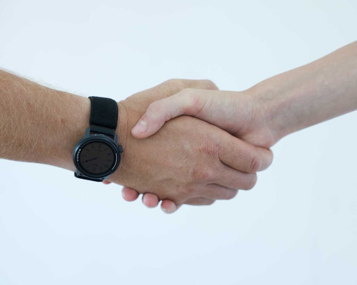 Two people shake hands.
