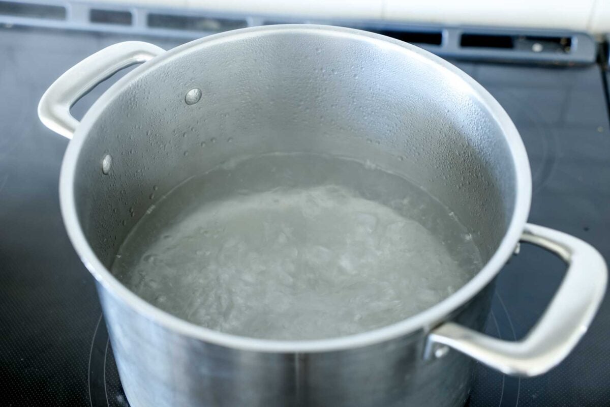 Water comes to a boil in a pot.