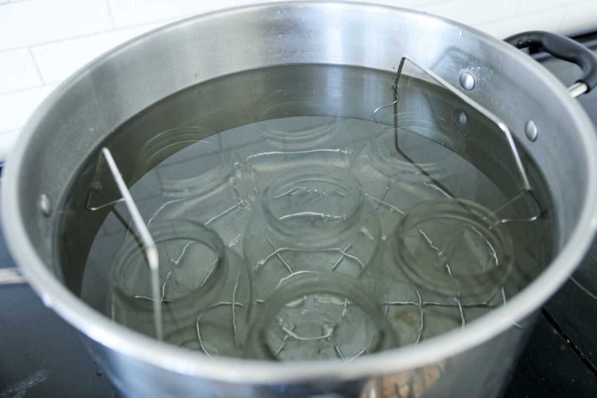 Mason jars are submerged in water in a waterbath canner.
